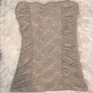 Strapless, beige, fitted shirt.